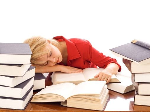 Woman asleep on books