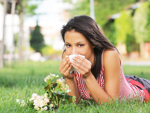 young woman in green park, spring allergy and pollen of flower