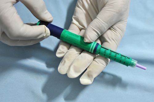 A medical assistant holds an insulin pen